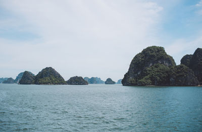 Rocks in sea against sky