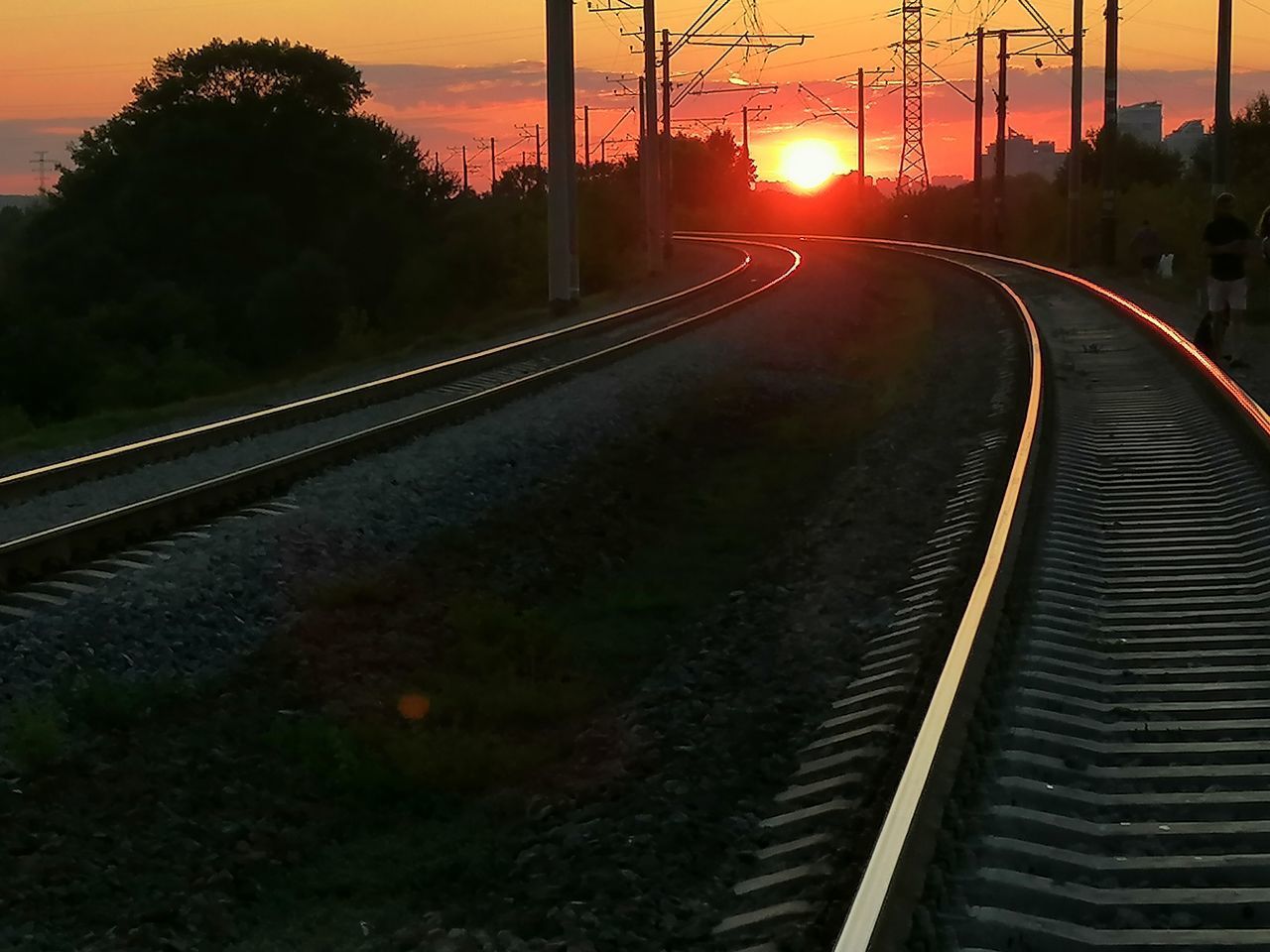 VIEW OF RAILROAD TRACKS DURING SUNSET