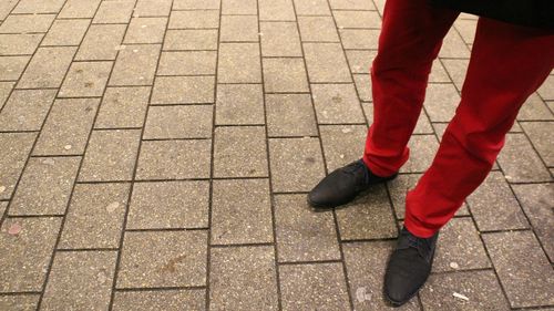 Low section of man standing on floor