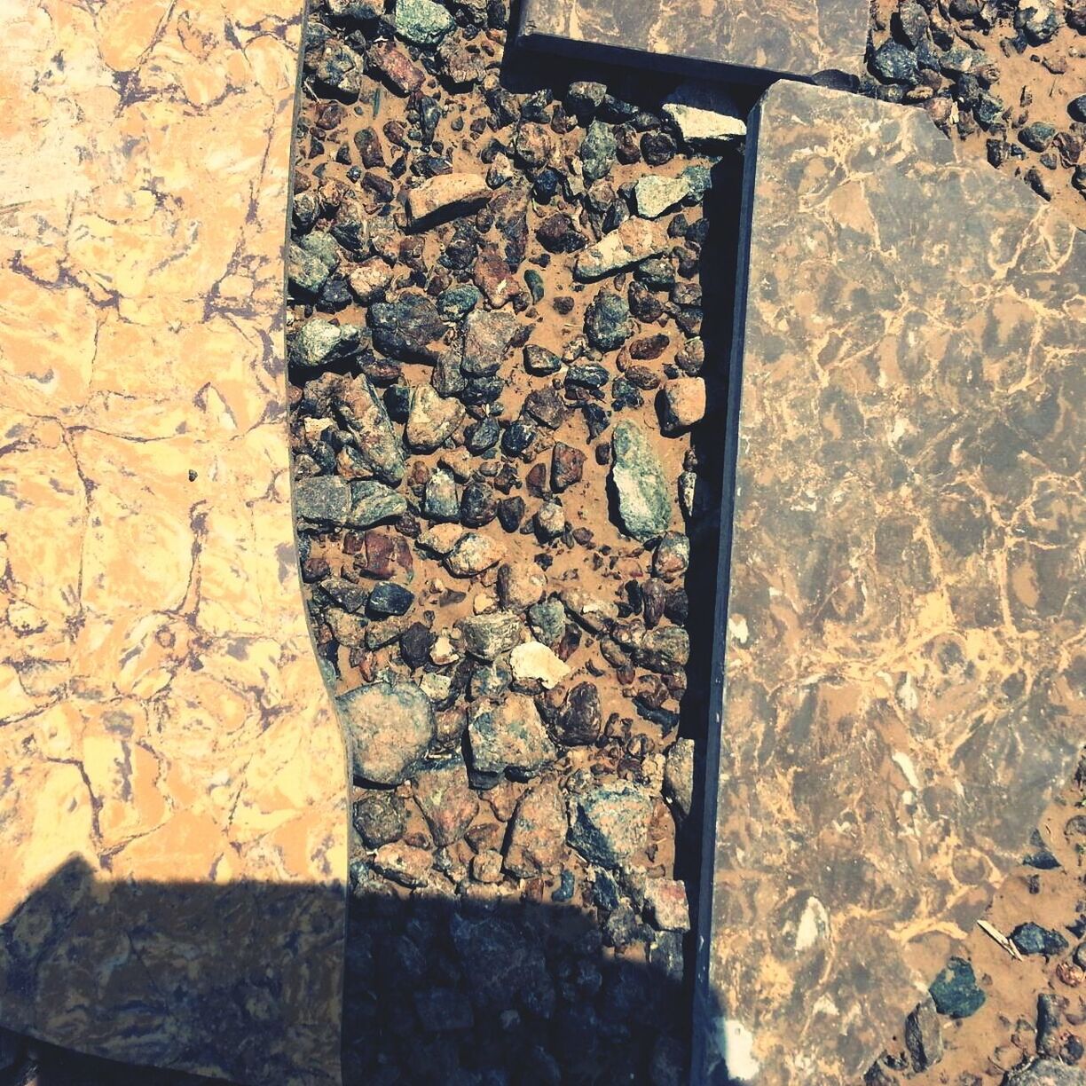 textured, high angle view, stone - object, rock - object, sunlight, pattern, day, outdoors, rough, cracked, shadow, puddle, nature, built structure, wall - building feature, no people, reflection, close-up, stone, water