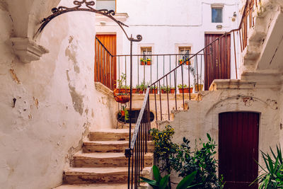 Low angle view of staircase amidst buildings