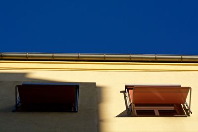 Low angle view of building against clear blue sky