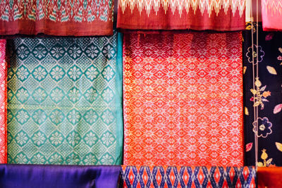 Full frame shot of colorful clothes hanging in store