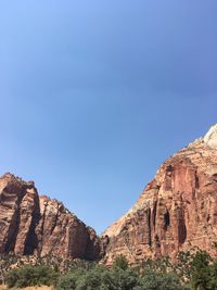 Rock formations on mountain against blue sky