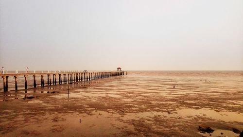 Pier on sea against clear sky