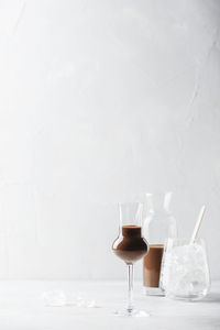 Wine glass on table against white background