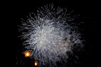 Low angle view of firework display against sky at night