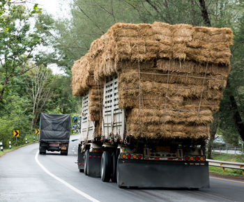 Stack of hay in semi-truck on street
