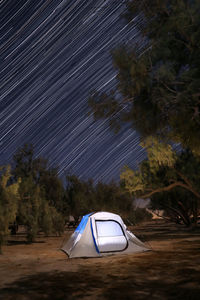 Tent on field against sky at night