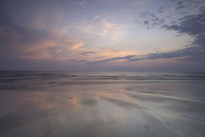 Scenic view of beach against sky during sunset