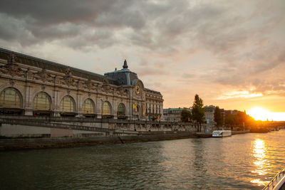 View of buildings against cloudy sky during sunset