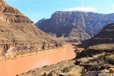 Scenic view of river and rocky mountains