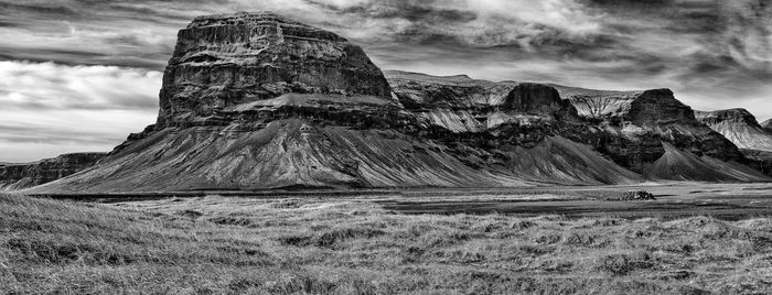 Rock formations on landscape against sky