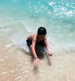 Full length of shirtless man in sea