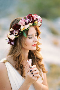 Close-up of young woman with bouquet