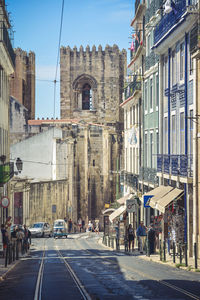 View of city street and buildings against sky