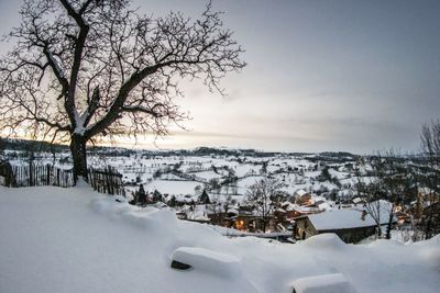 Scenic view of snow covered field against sky