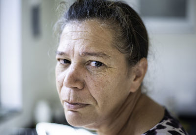 Close-up portrait of woman at home