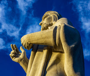 Low angle view of statue against blue sky