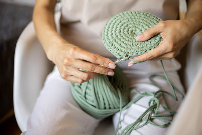 Midsection of woman holding seashell