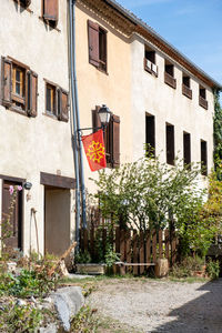 Flag of occitanie hoisted in front of a house in montsegur, south france