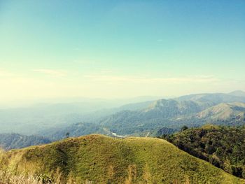 Scenic view of mountains against blue sky