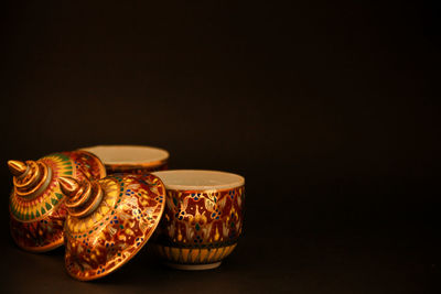 Close-up of art on table against black background