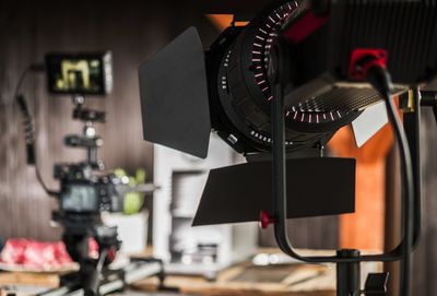 Close-up of camera with spot light at studio