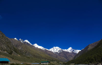 Scenic view of mountains against clear blue sky