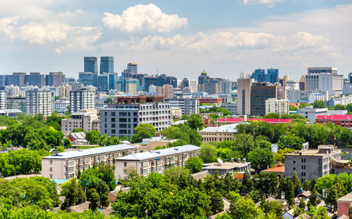 Cityscape against cloudy sky