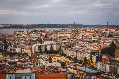 High angle view of townscape by sea against sky