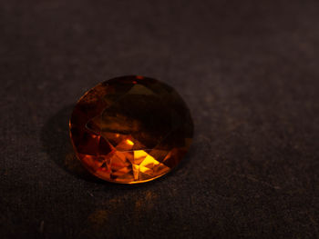 Close up shoot of faceted orange diamond like gems. shoot on a black background