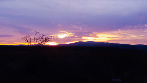 Silhouette of landscape against dramatic sky