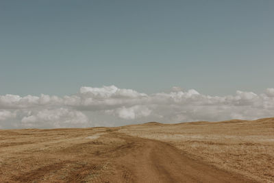 Scenic view of arid landscape against sky