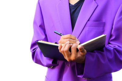 Close-up of man using mobile phone against white background