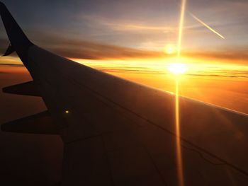 Close-up of airplane against sky during sunset