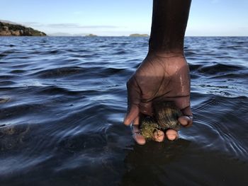 Midsection of man in sea