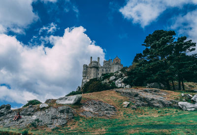 Low angle view of building against cloudy sky