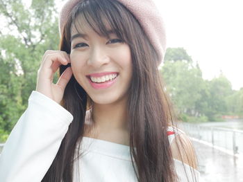 Portrait of smiling young woman using smart phone