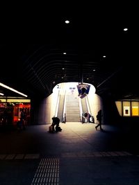 Full length of illuminated people at night