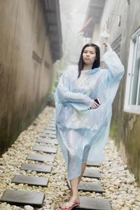 Full length of woman standing on staircase