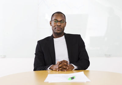Portrait of smiling businessman sitting in office