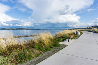 Billowing clouds hover over the puget sound and dune peninsula park in tacoma, washington.