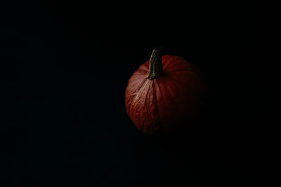 Close-up of orange on table against black background