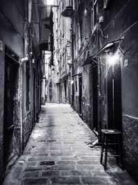 Narrow walkway along buildings at night