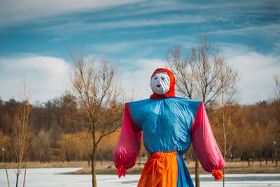 View of scarecrow on land against sky during winter