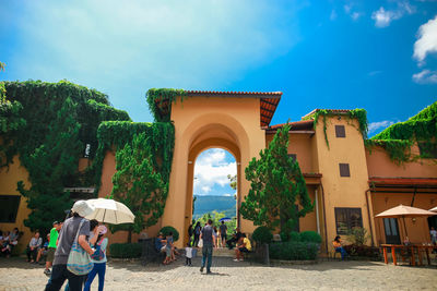 People by building against sky