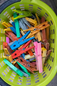 High angle view of multi colored clothespins in basket