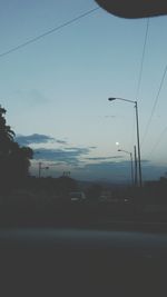 Cars on road in city against sky