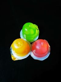 Close-up of multi colored candies against black background